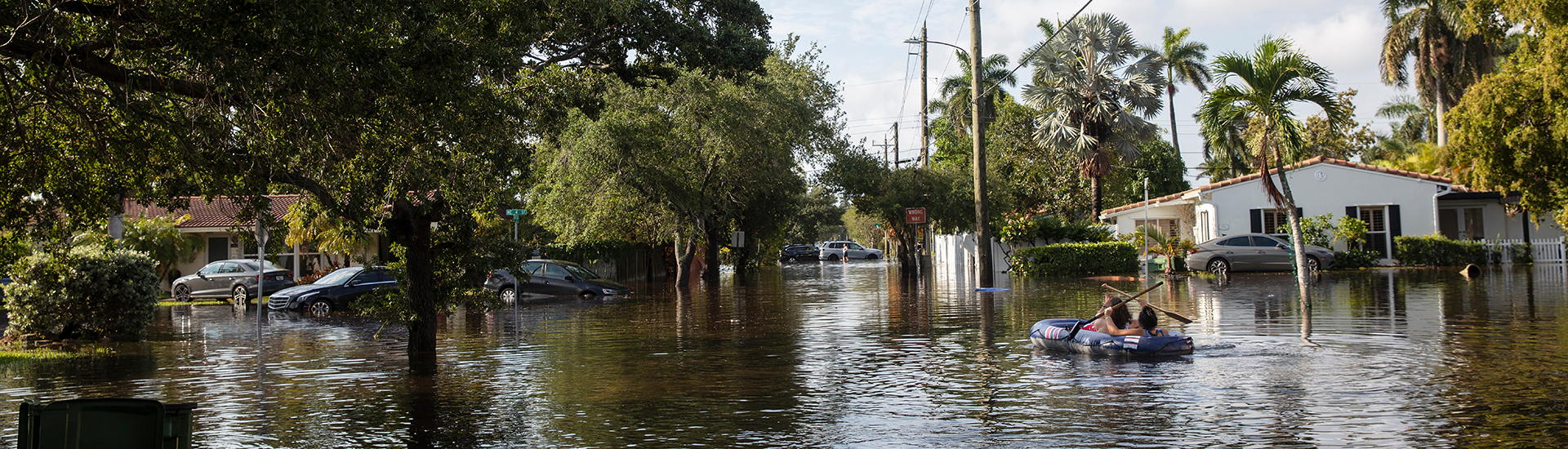 Couple in an inflatable raft navigates flooded streets in South Florida