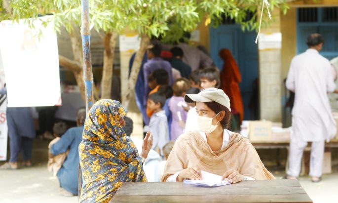 researcher conducting an interview in a medical camp