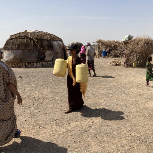 woman with water jugs in northern Kenya