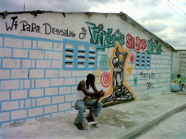 man in front of graffitti Haiti