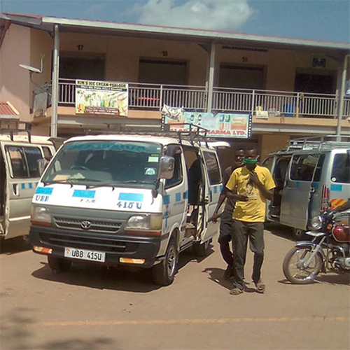 two men stand by parked vans